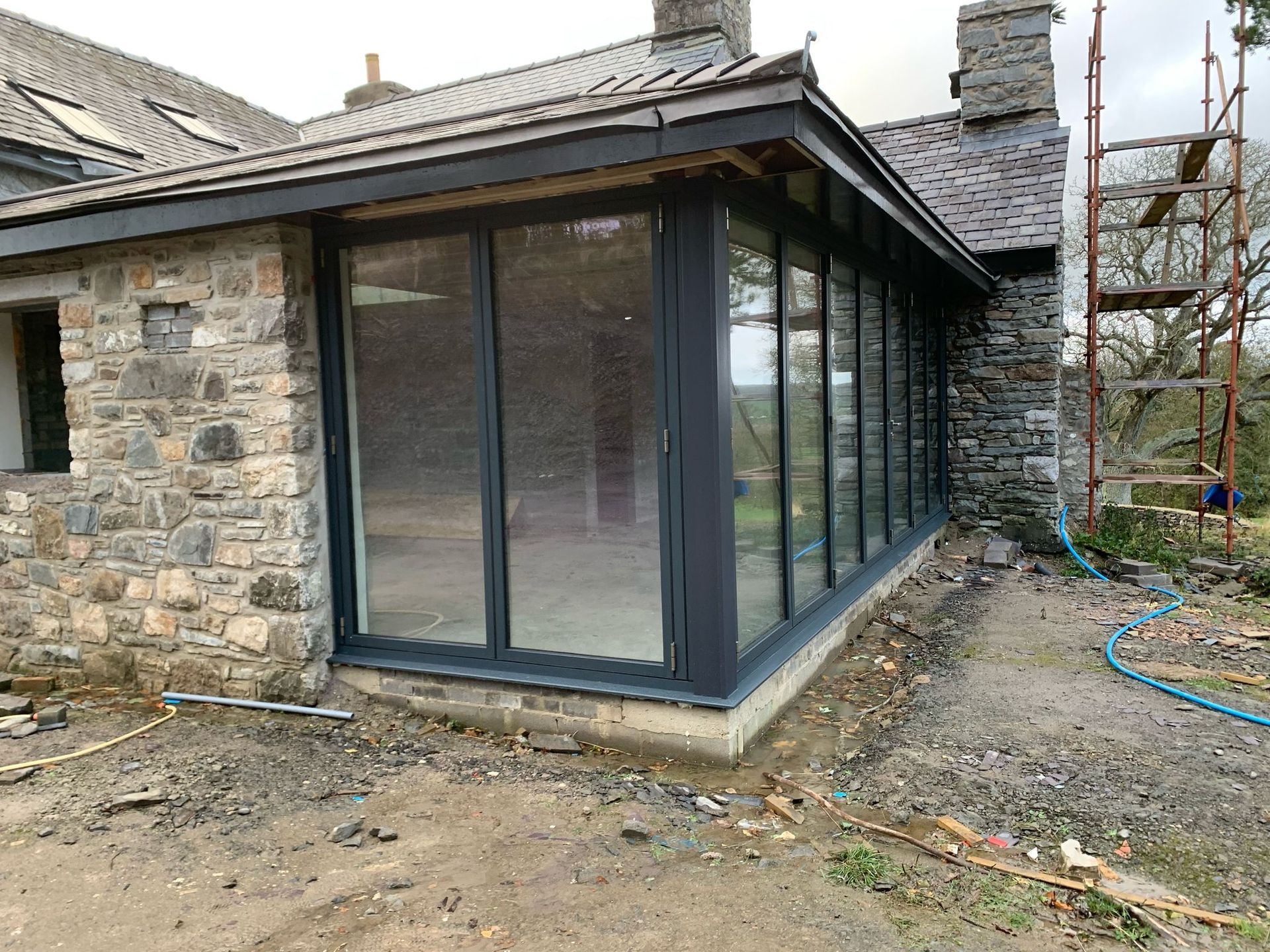 A house with a lot of windows is being built.