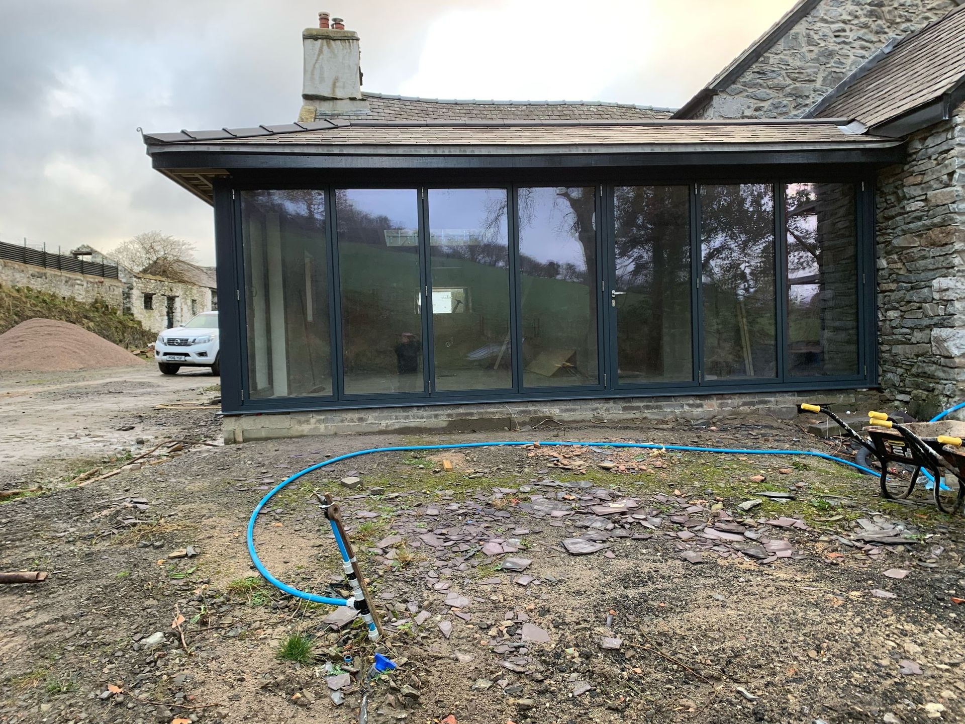A large house with a lot of windows and a hose in front of it.