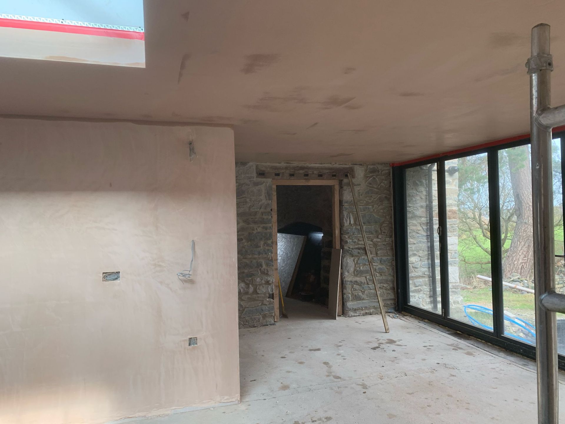 A room with a lot of windows and a door.