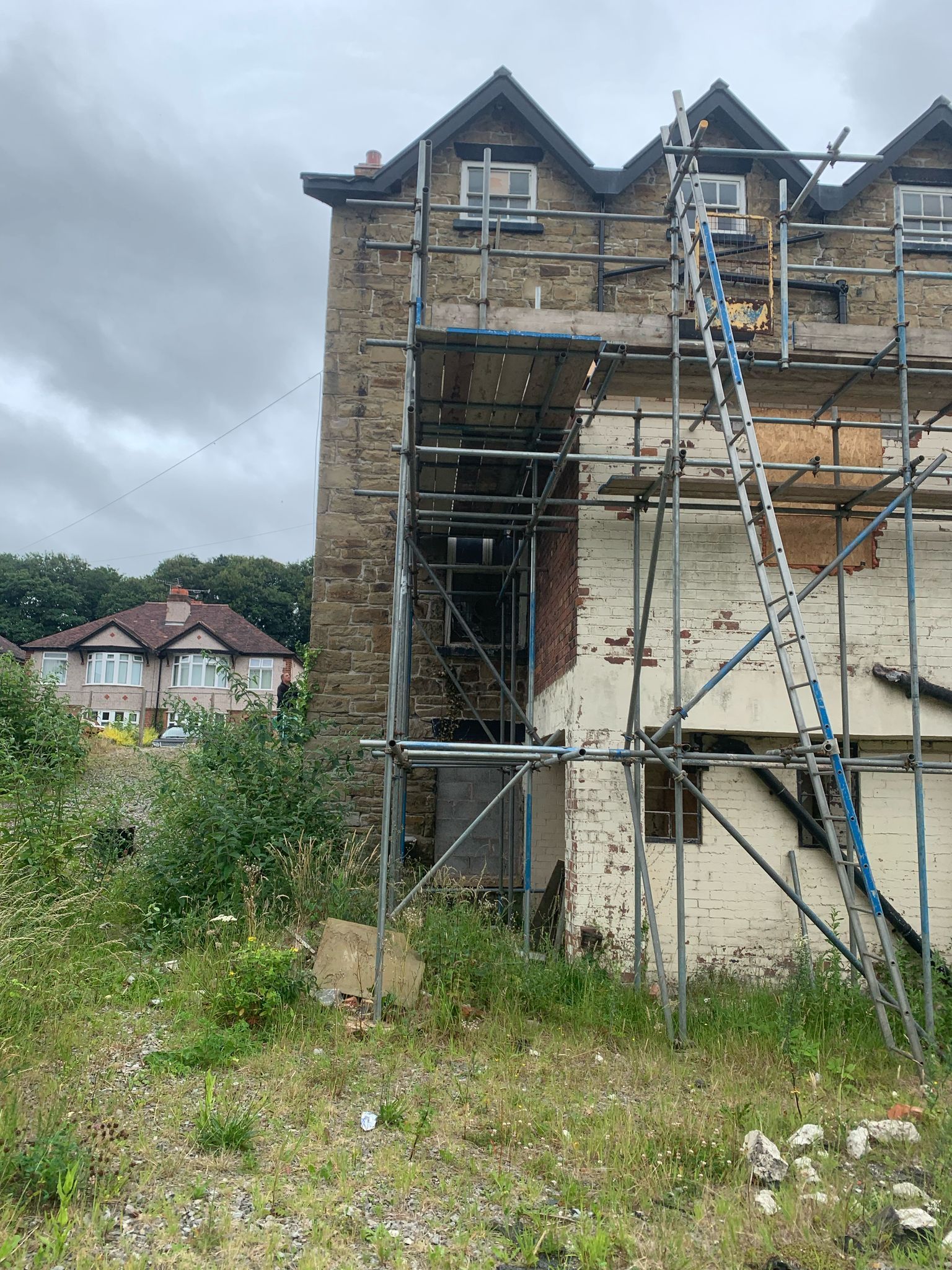 A building with scaffolding around it and a ladder on the side of it.