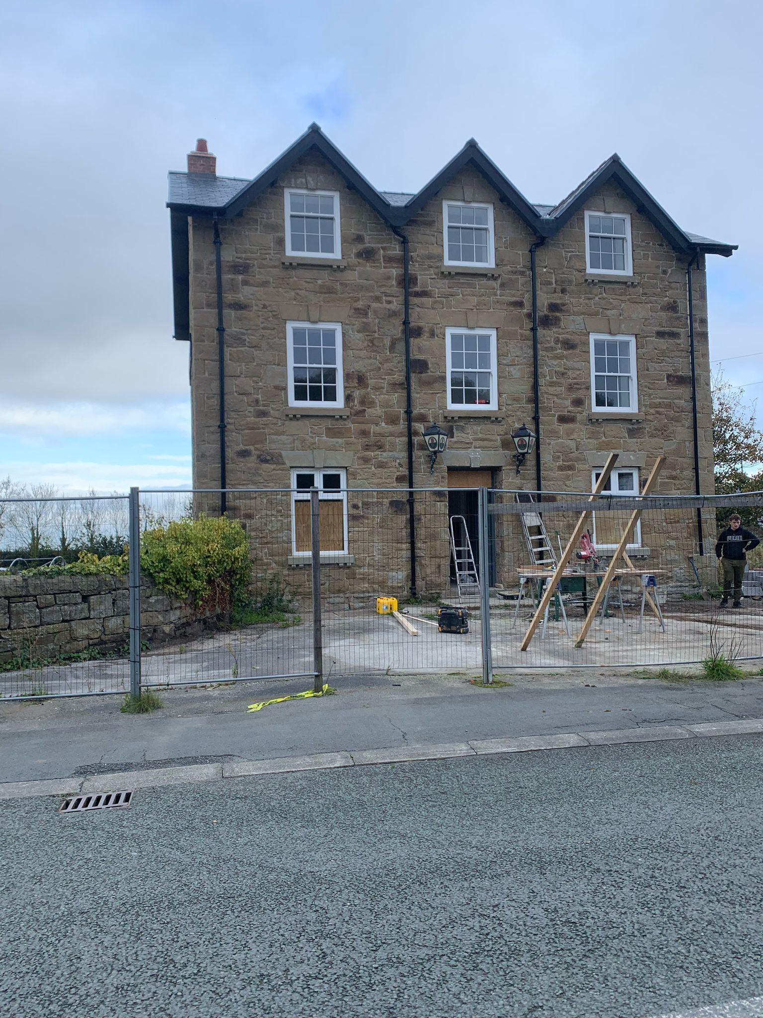 A large brick building with a lot of windows is being remodeled.