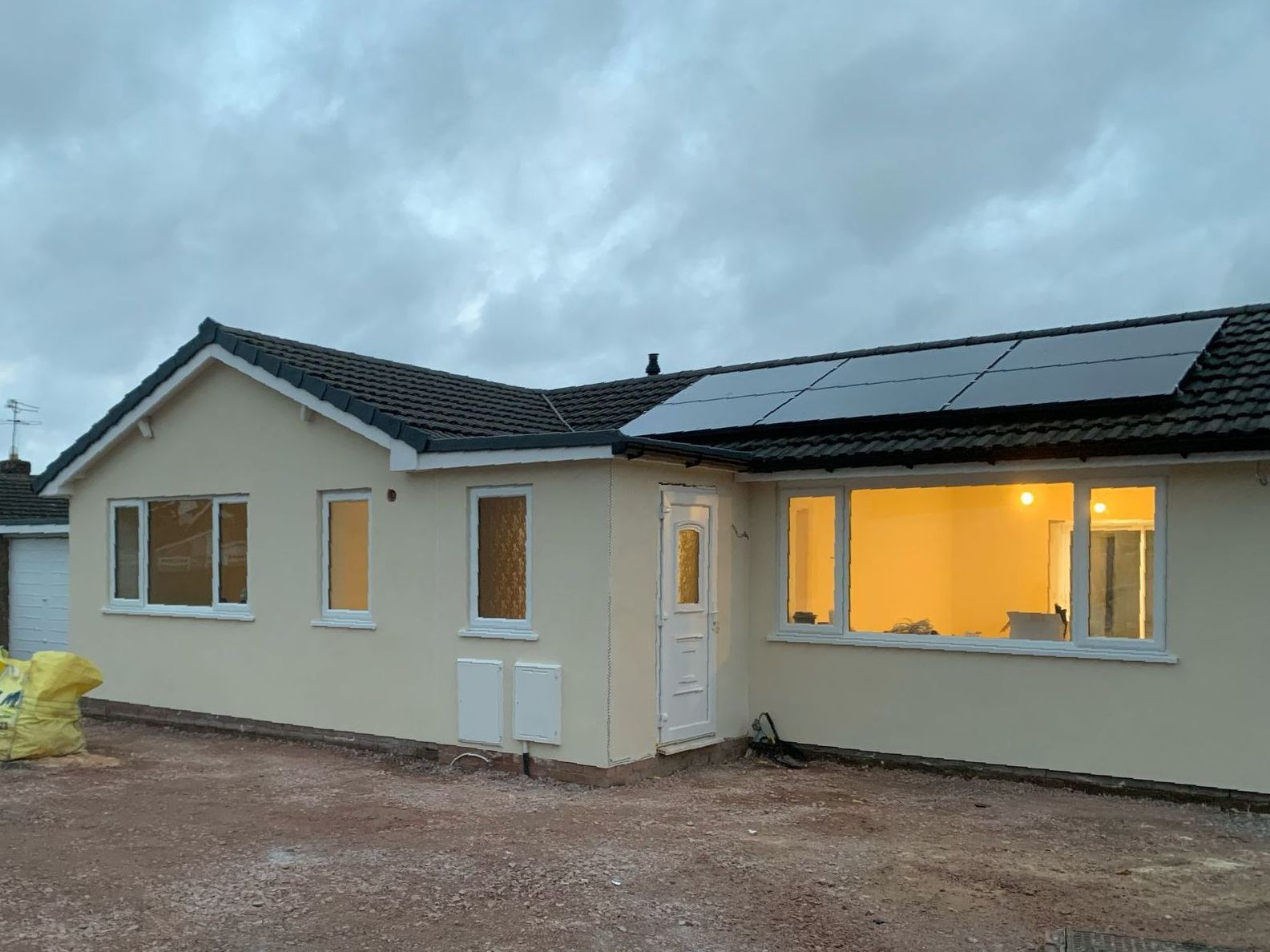 A house with a lot of windows and solar panels on the roof