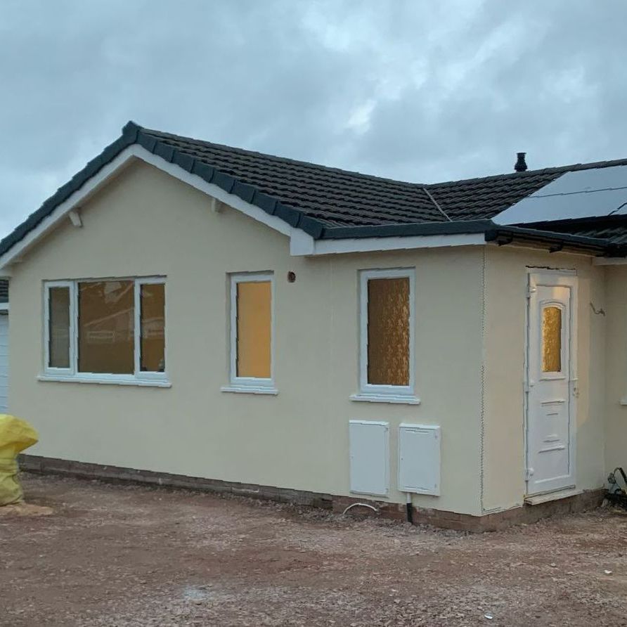 A small house with a solar panel on the roof