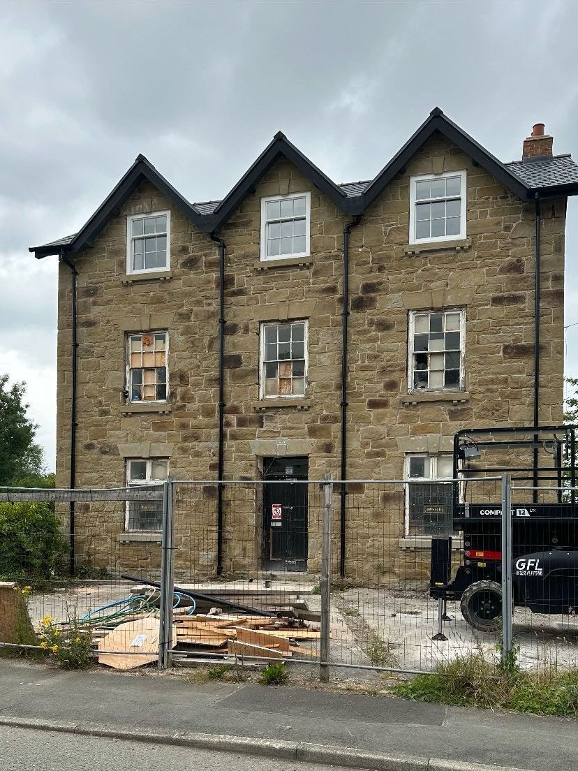 A large brick building with a truck parked in front of it.