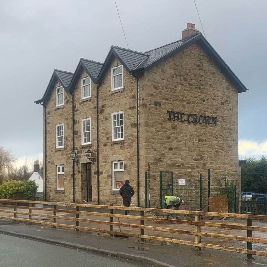 A large stone building with the word the crown on it