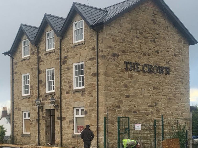 A large stone building with the word the cooper on it