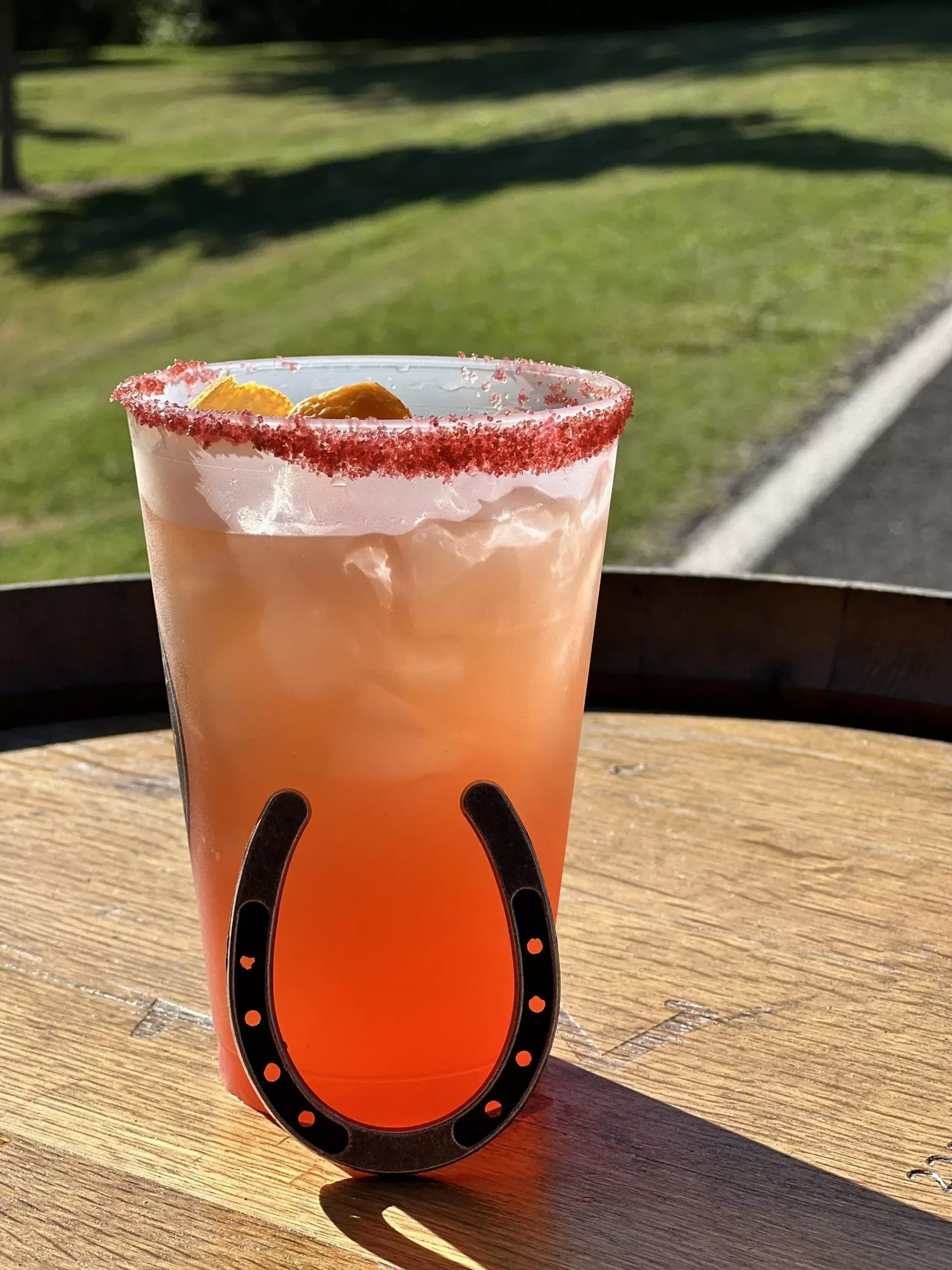 A drink in a cup with a horseshoe on it