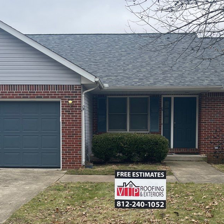 A house with a free estimate sign in front of it.