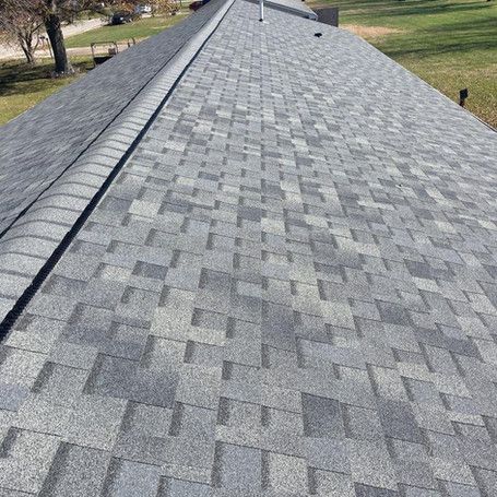 A close up of a roof with a lot of shingles on it.
