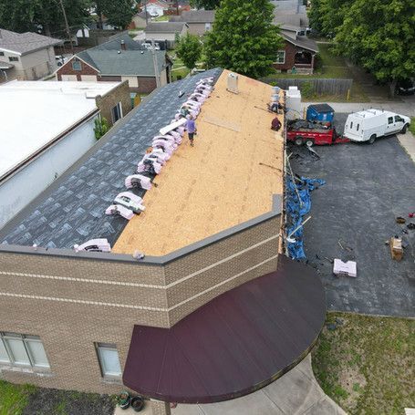 An aerial view of a roof being installed on a building.