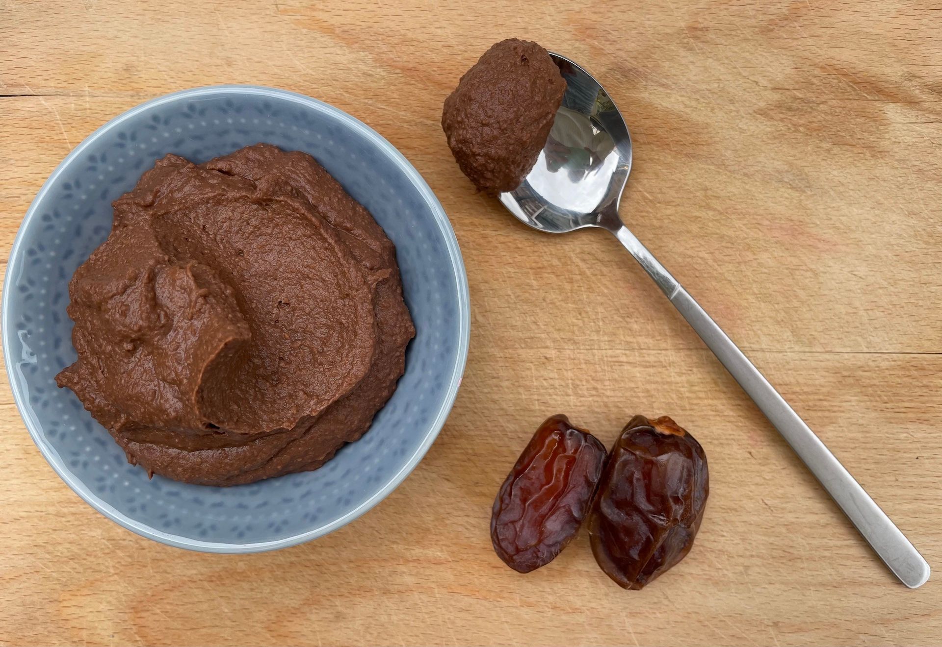 Chocolate hummus with spoon and dates