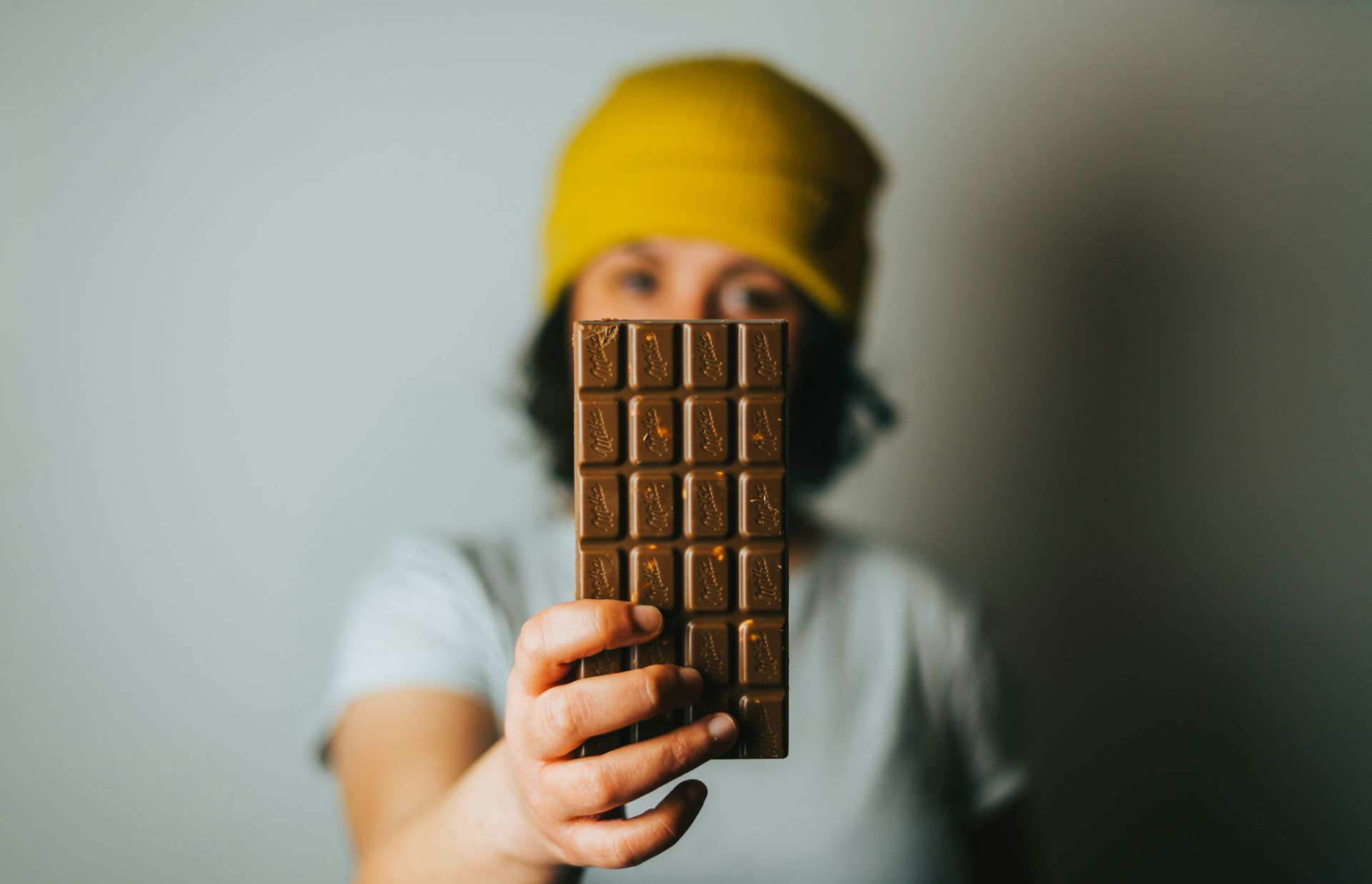 Woman holding up a bar of chocolate