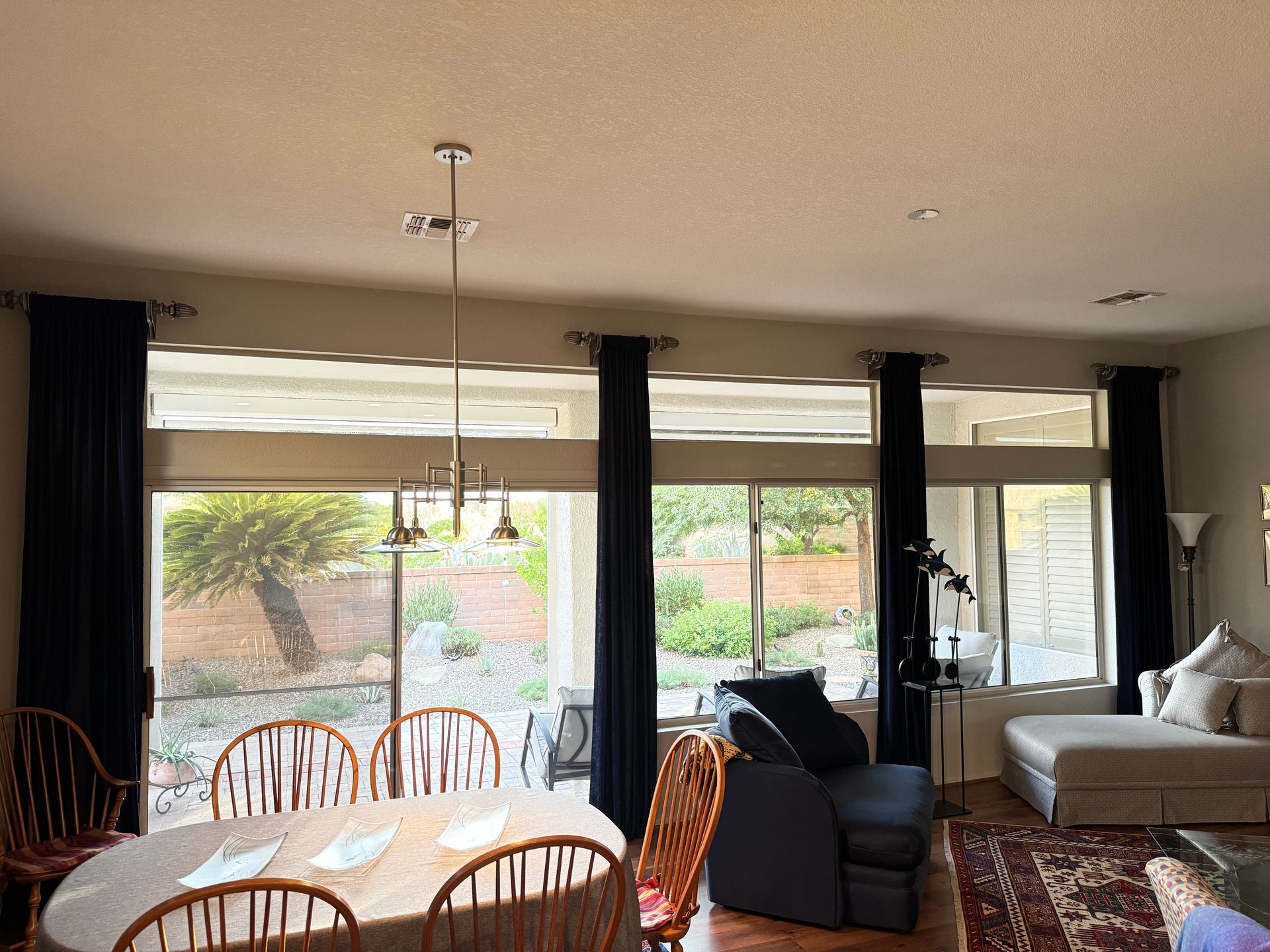 motorized blinds covering large windows leading to outside