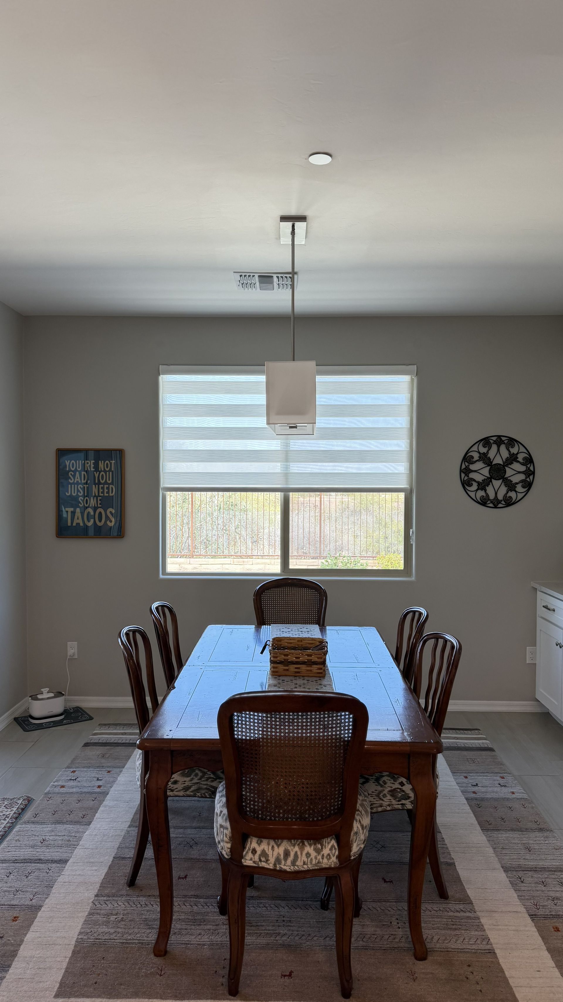 Living room with a sectional sofa, TV, and window with blinds.