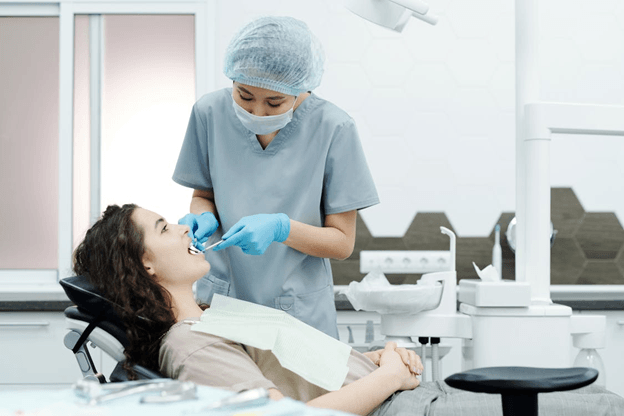 Dentist Checking Patient’s Teeth | Dental Care Grants