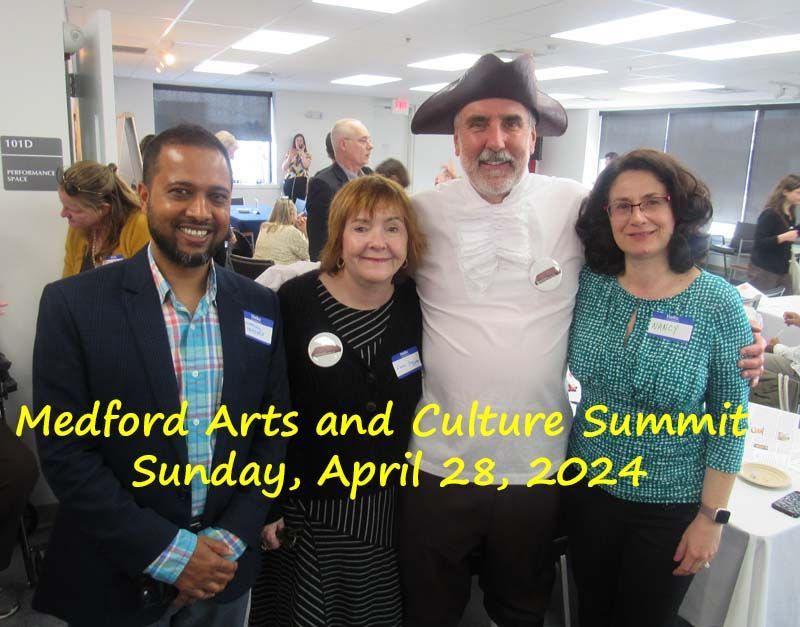 A group of people posing for a photo at the medford arts and culture summit