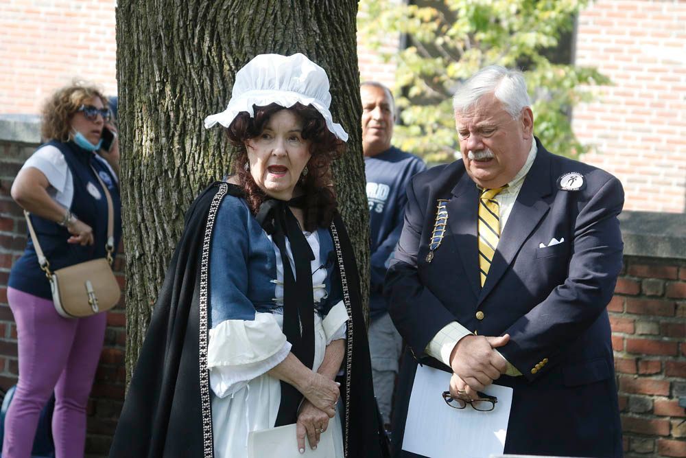 A woman in a blue dress is standing next to a man in a suit and tie.
