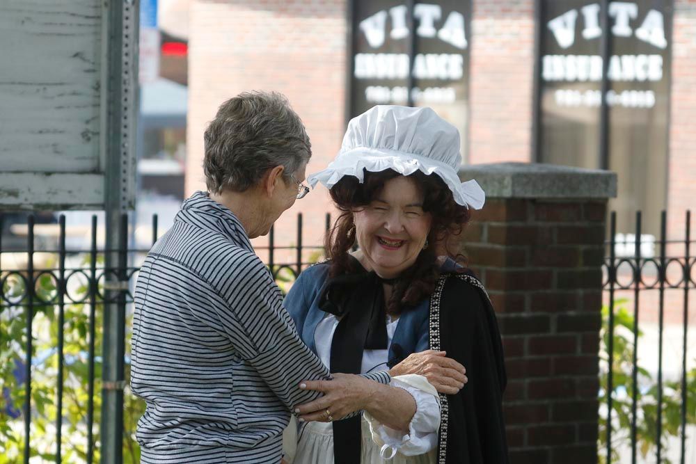 Two women are talking in front of a vita store