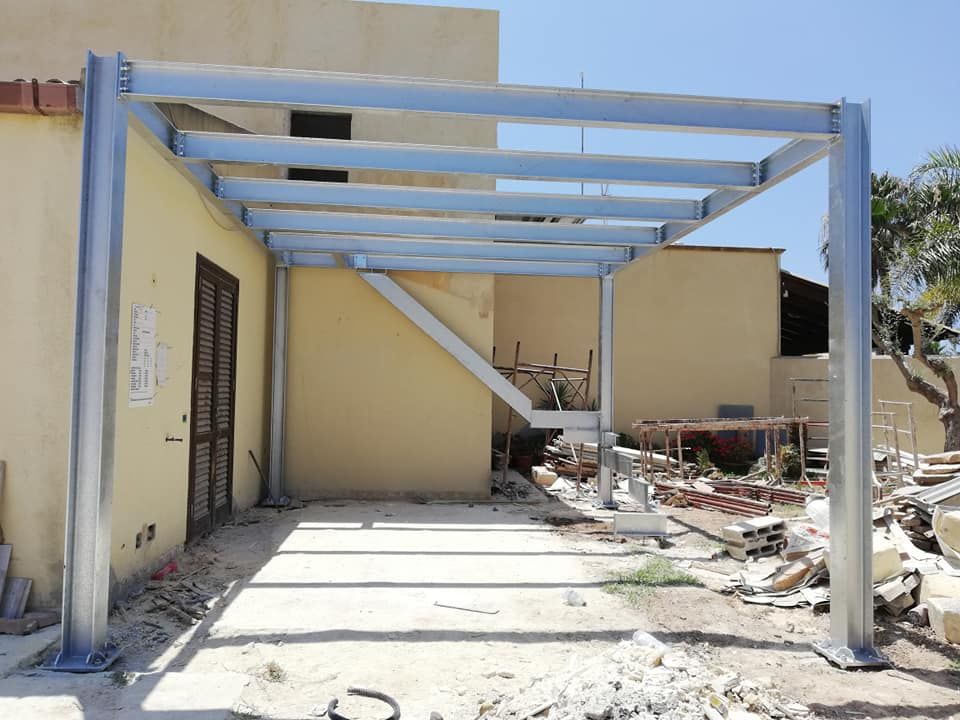 Una struttura metallica viene costruita di fronte a un edificio