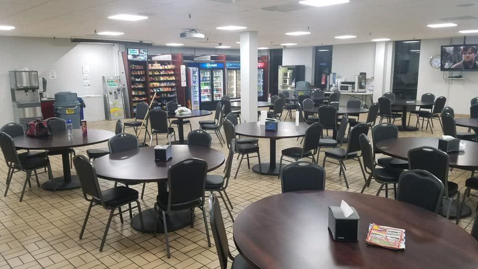 A large room with tables and chairs in it