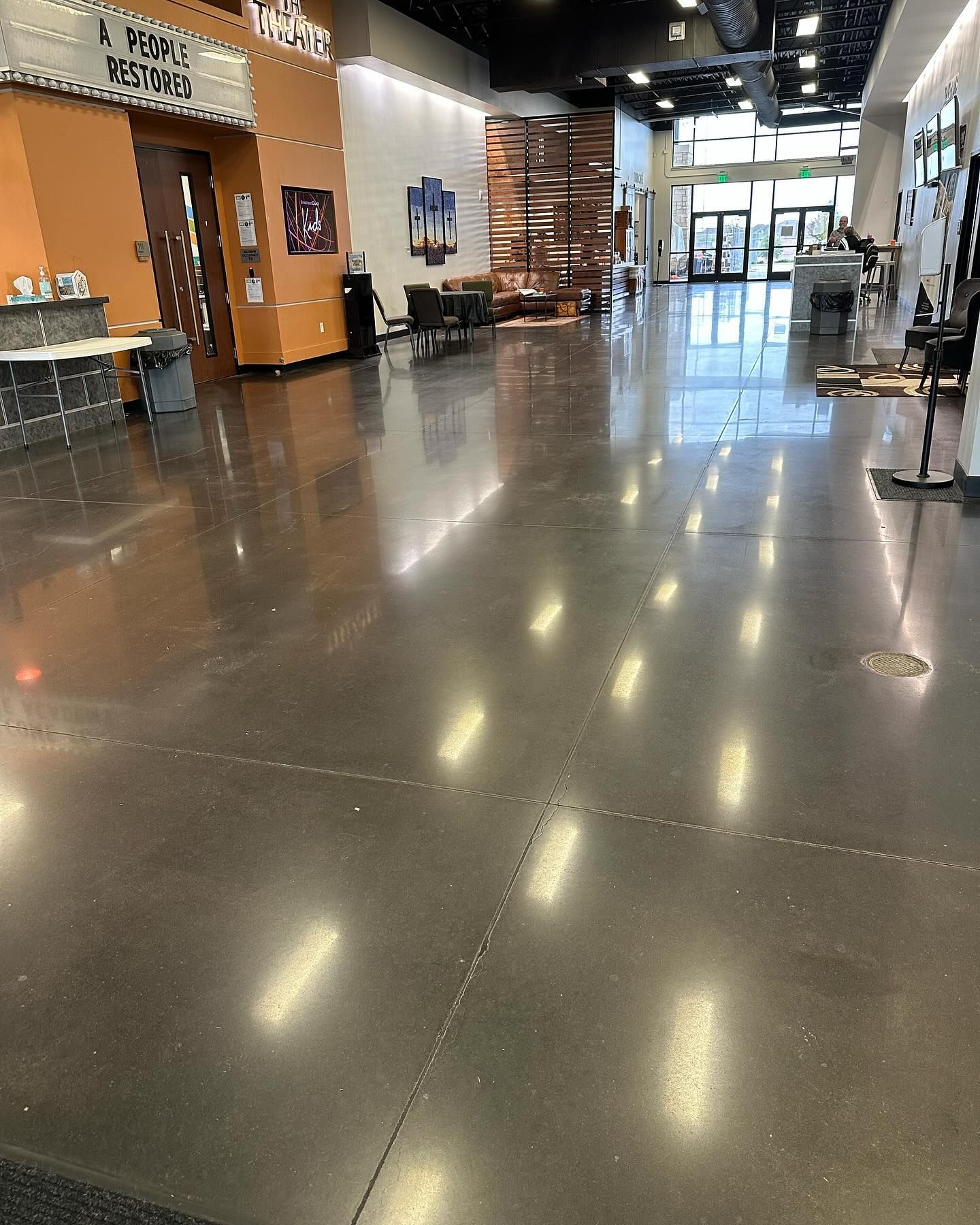 A large hallway with a shiny concrete floor