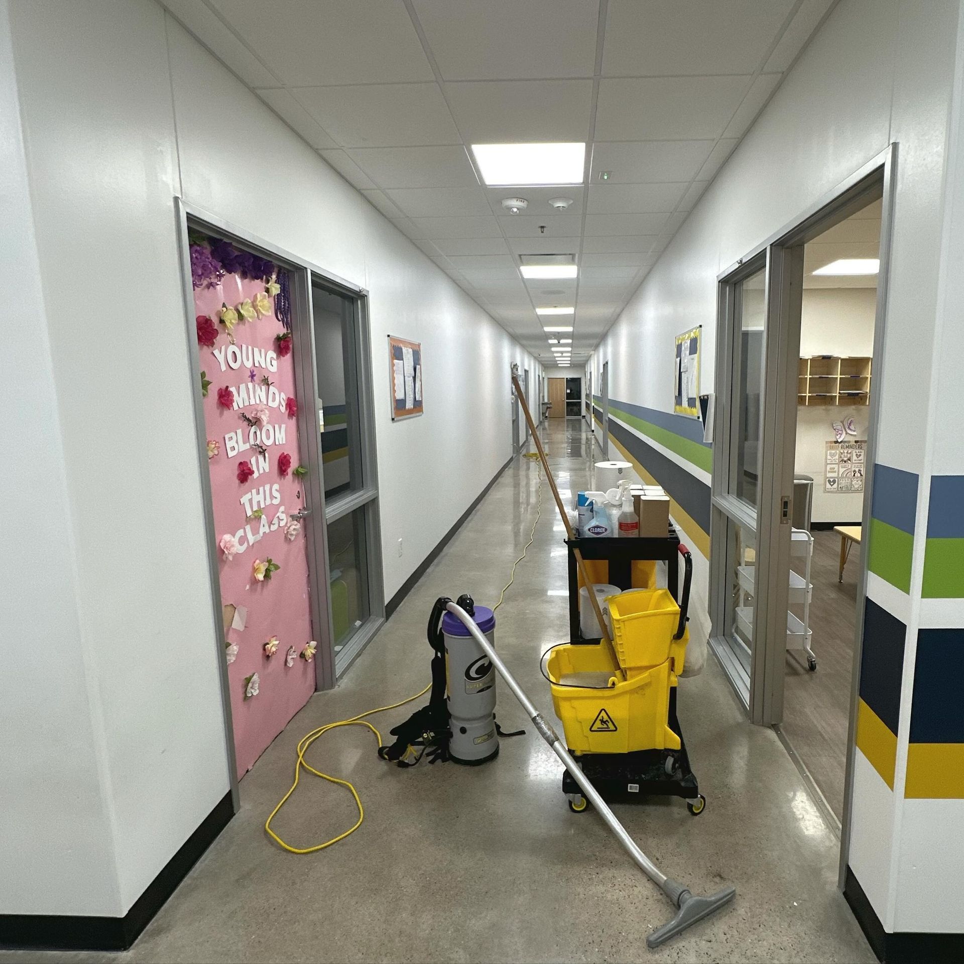 A long hallway with a sign on the wall that says 