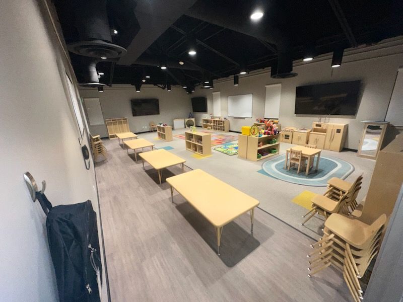 A large room with tables and chairs in it.