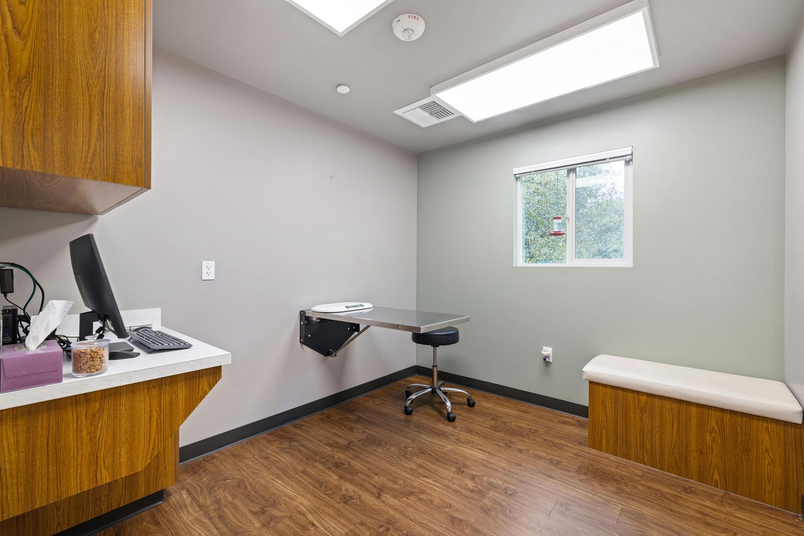 A veterinarian 's office with a desk and a computer.