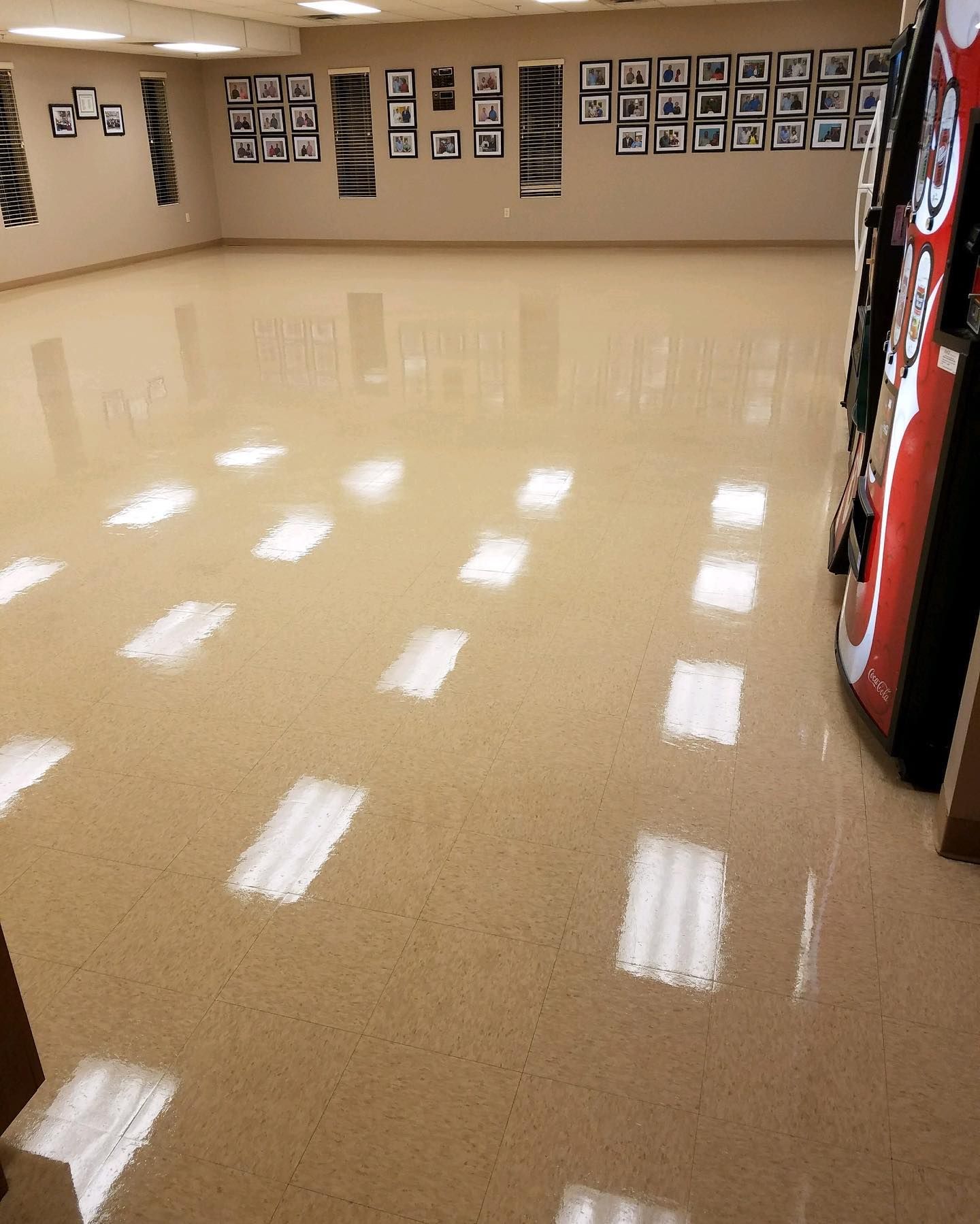 A large room with a coca cola vending machine