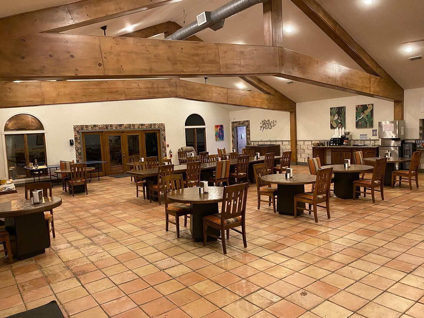 A large room filled with tables and chairs in a restaurant.