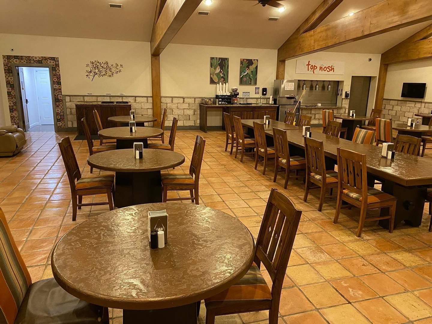 A large room with tables and chairs in a restaurant.