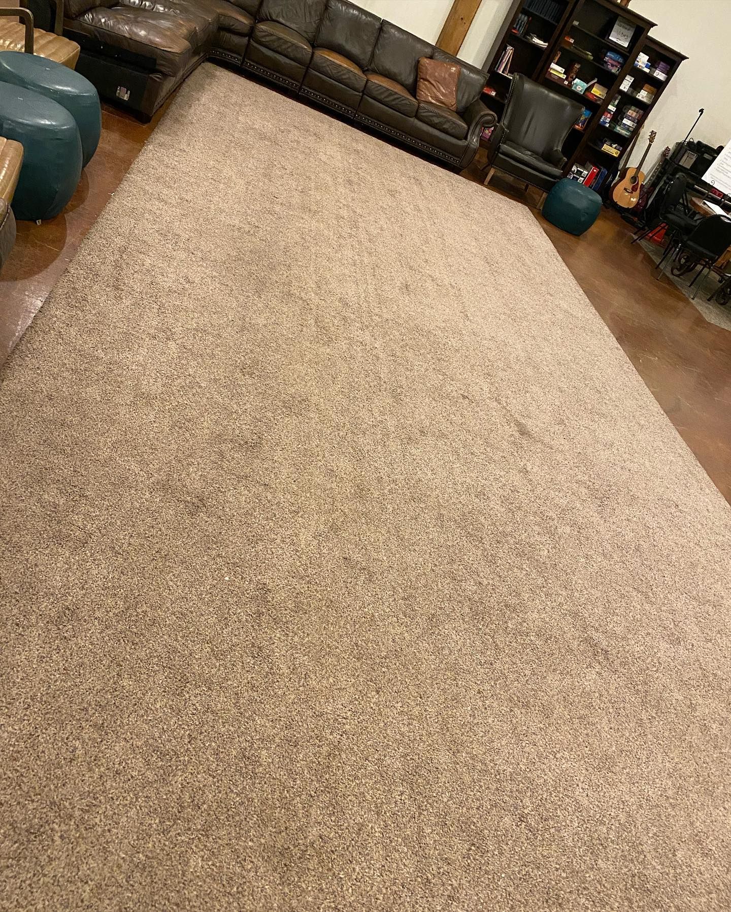 A living room filled with furniture and a large rug.