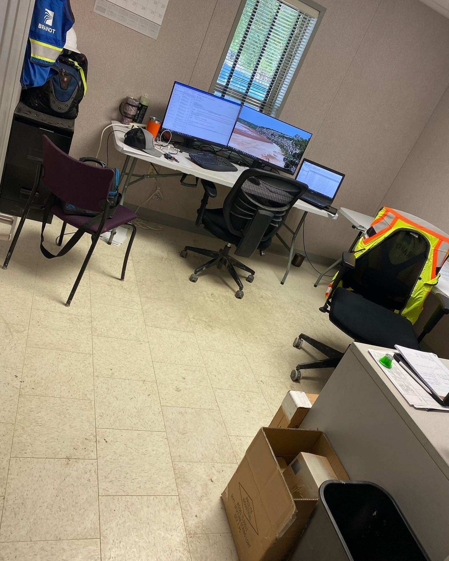 A room with a lot of computers and chairs