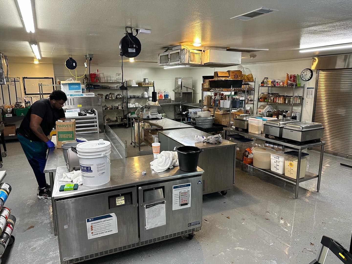 A man is standing in a kitchen preparing food.