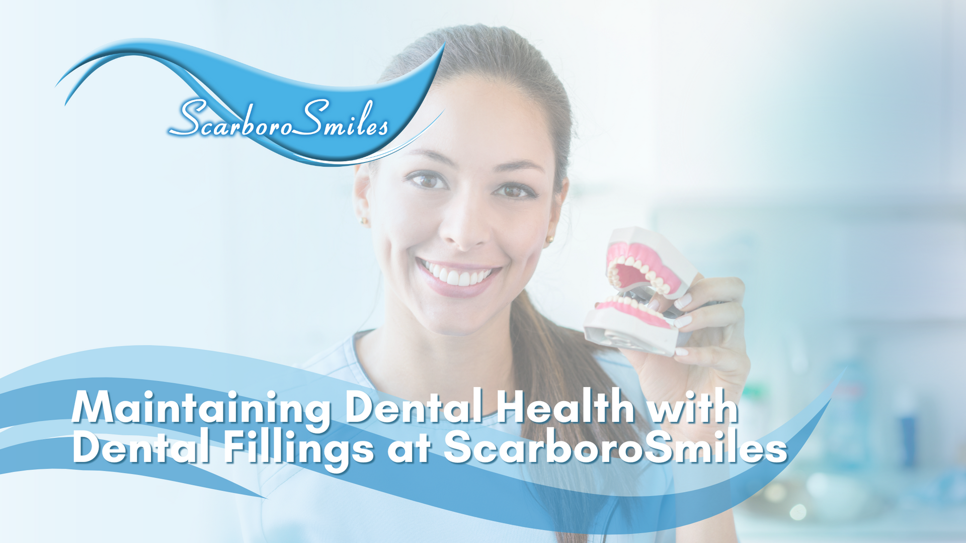 A woman is smiling while holding a model of her teeth.