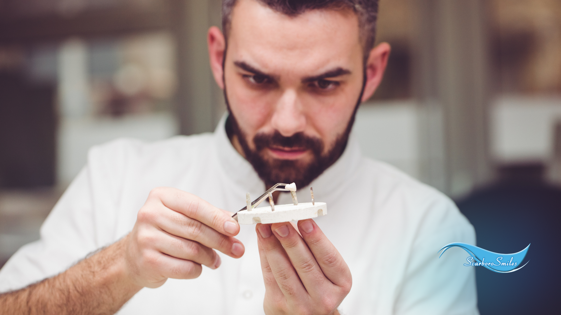 A man is holding a model of a car in his hands.