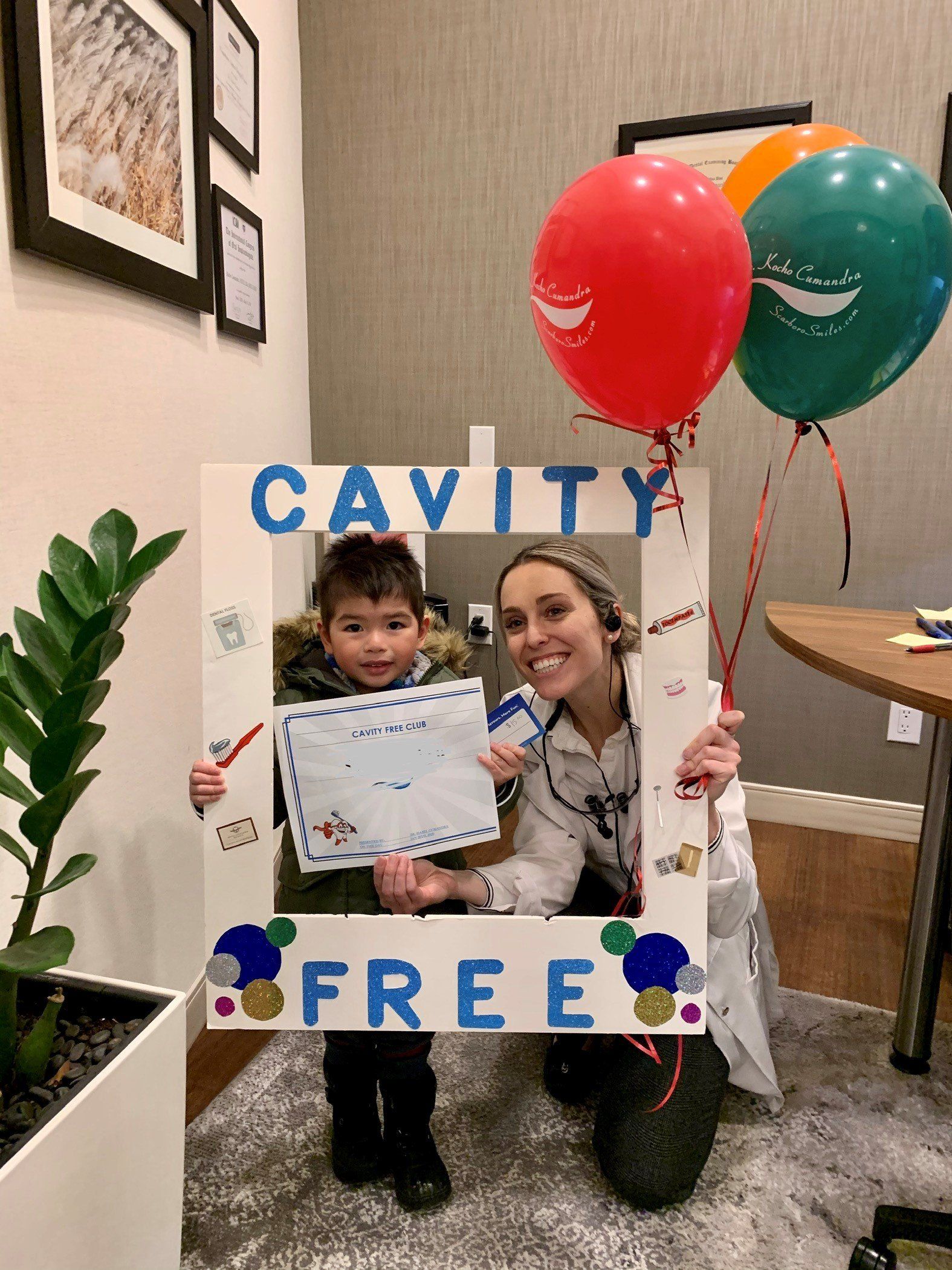 Cavity Free Club | Dr. Isabel Cumandra Smiling With A Child | Pediatric Dentistry | Family Dentistry | ScarboroSmiles | Best Dentist in Scarborough
