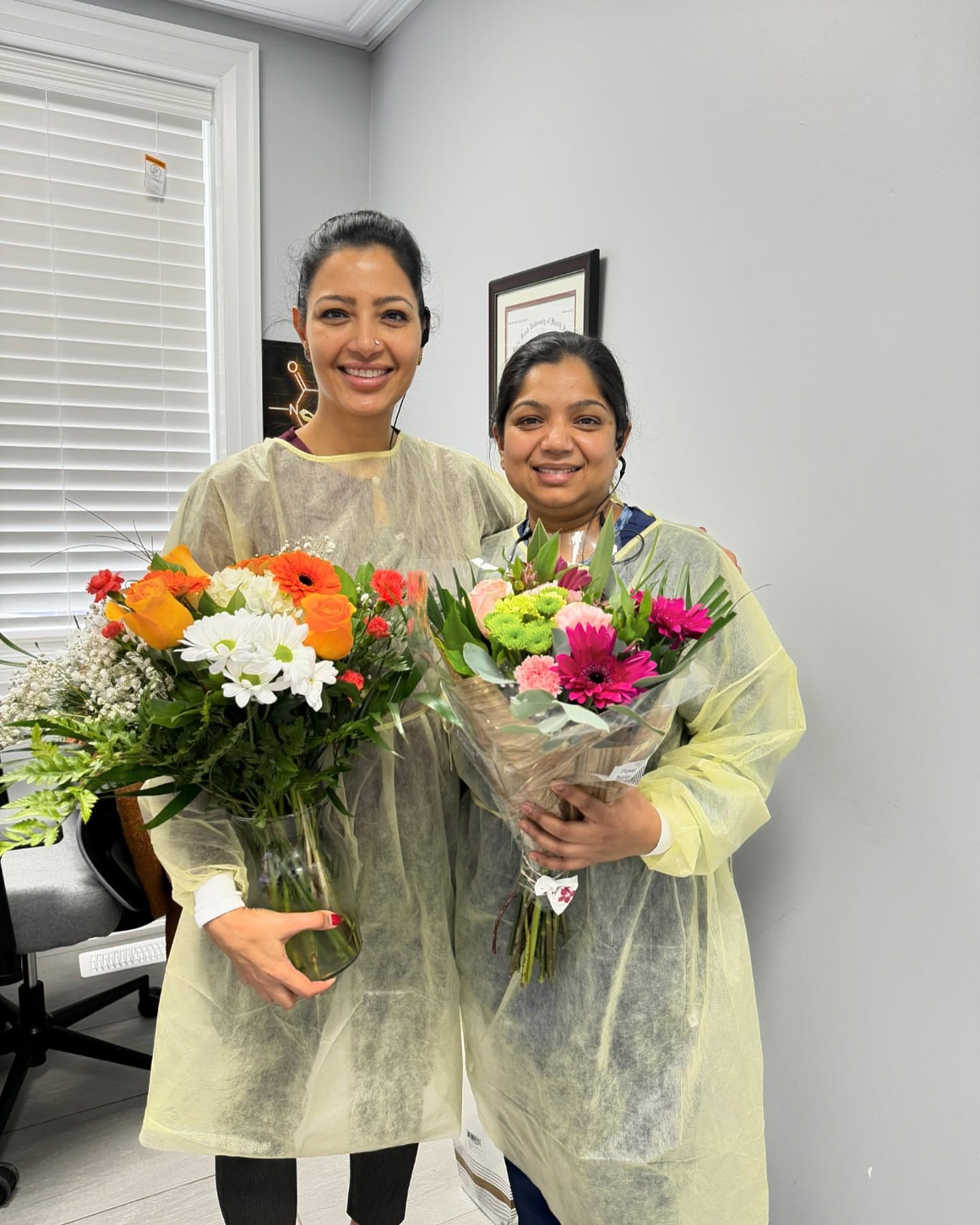 Dr. Amita Bajwa holding bouquets of flowers