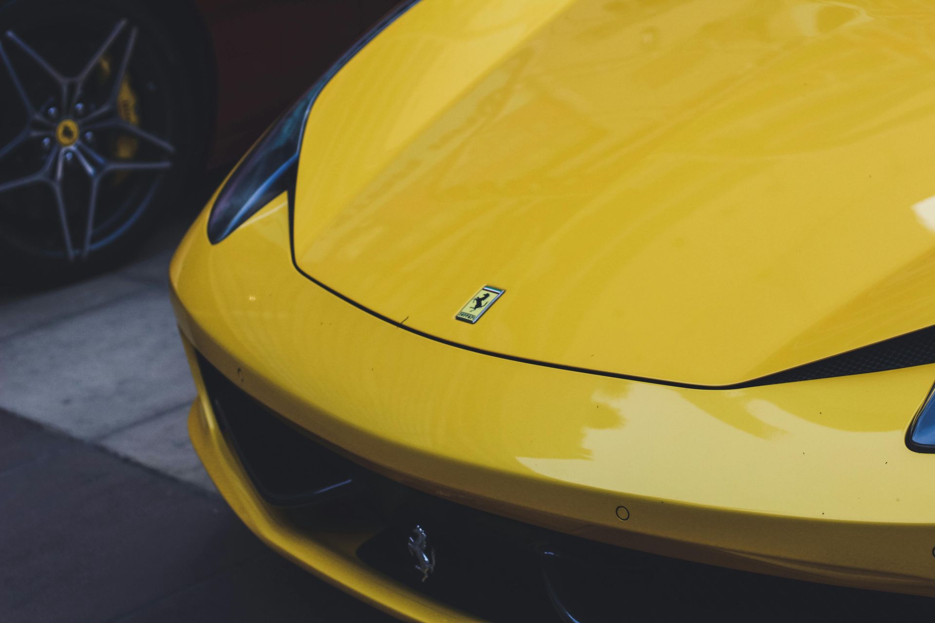 A close up of the front of a yellow sports car