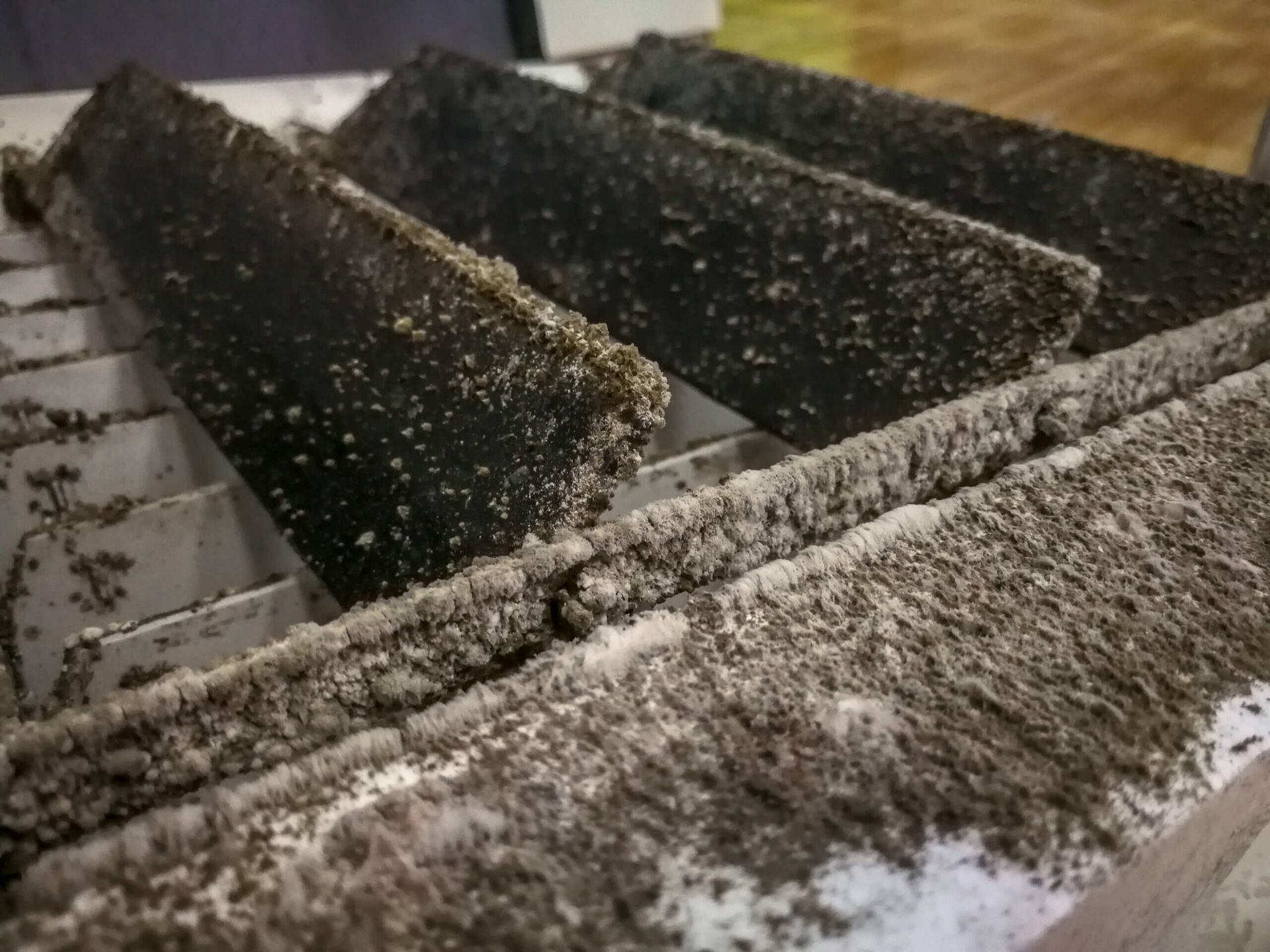 A close up of a dirty staircase with a lot of dust on it.