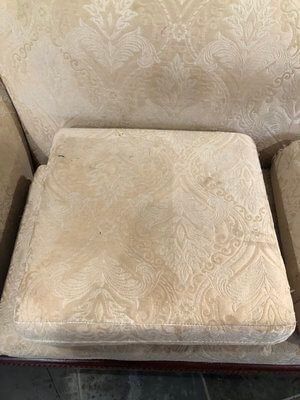 A close up of a cushion on a chair.