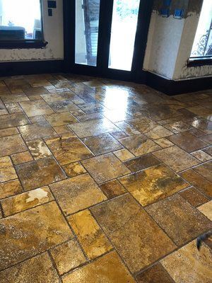 A tiled floor in a room with sliding glass doors.