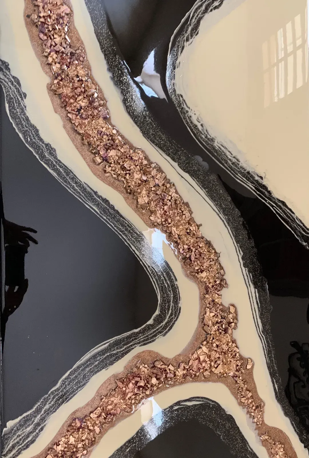 A close up of a black and white painting with glitter