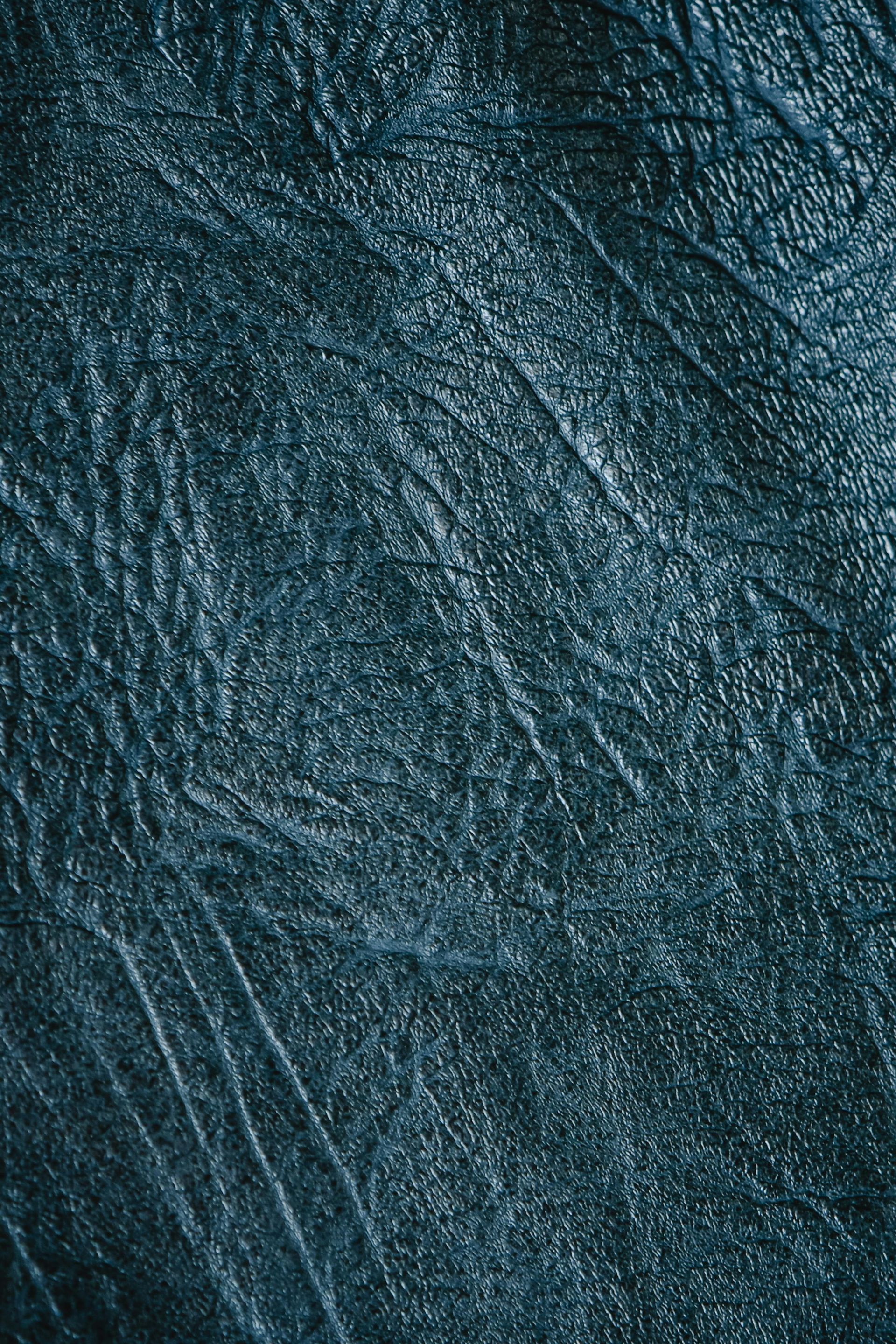 A close up of a blue leather texture.