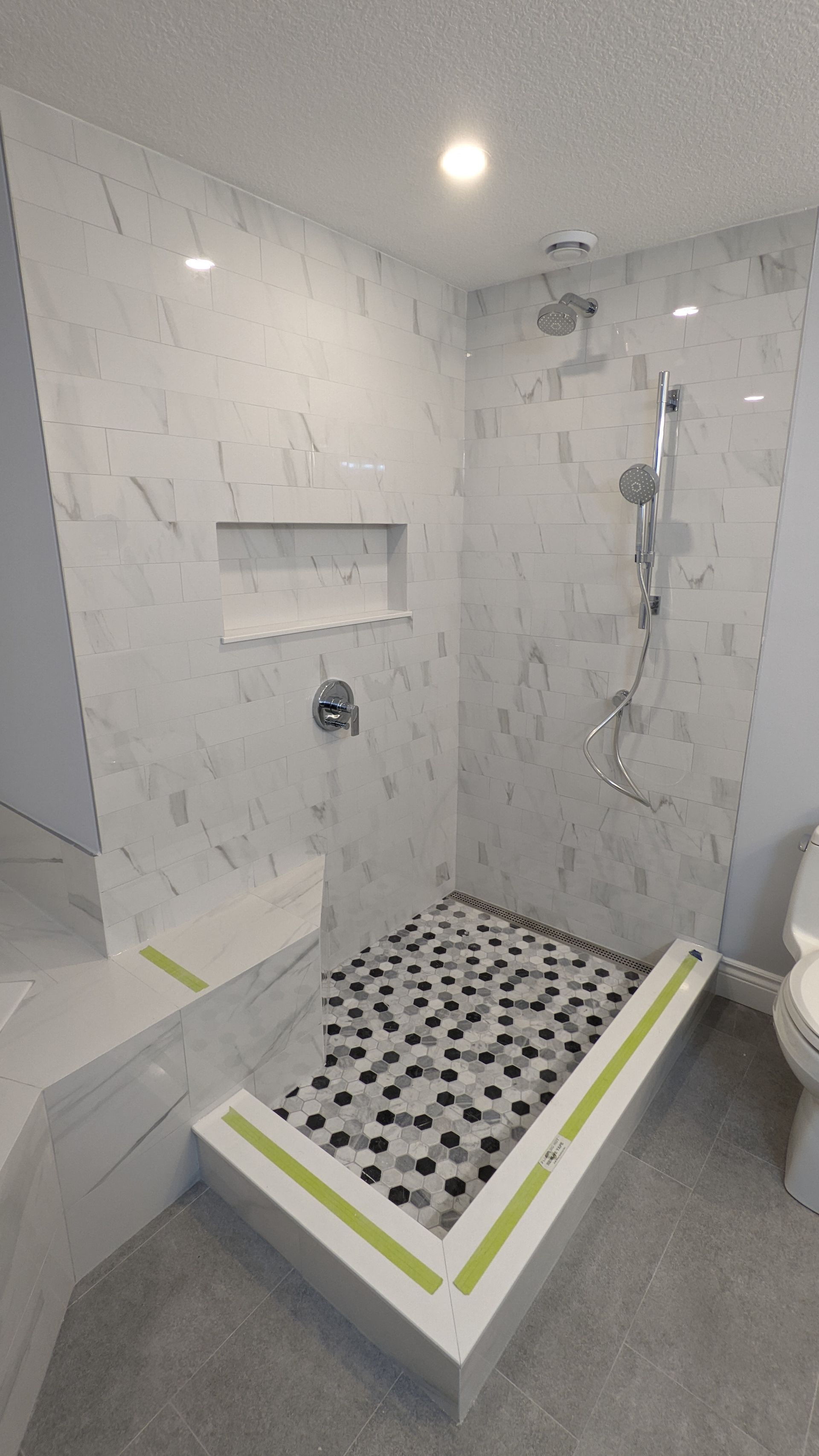 A bathroom with a walk in shower and a toilet.