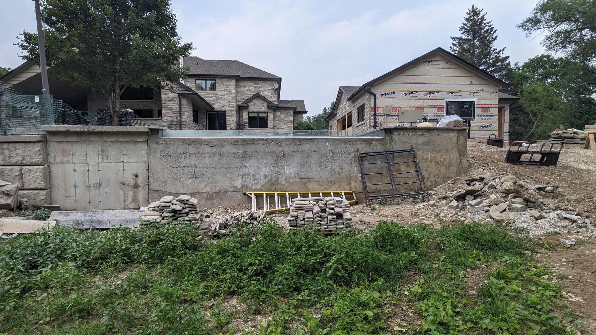 A large house is being built next to a smaller house.