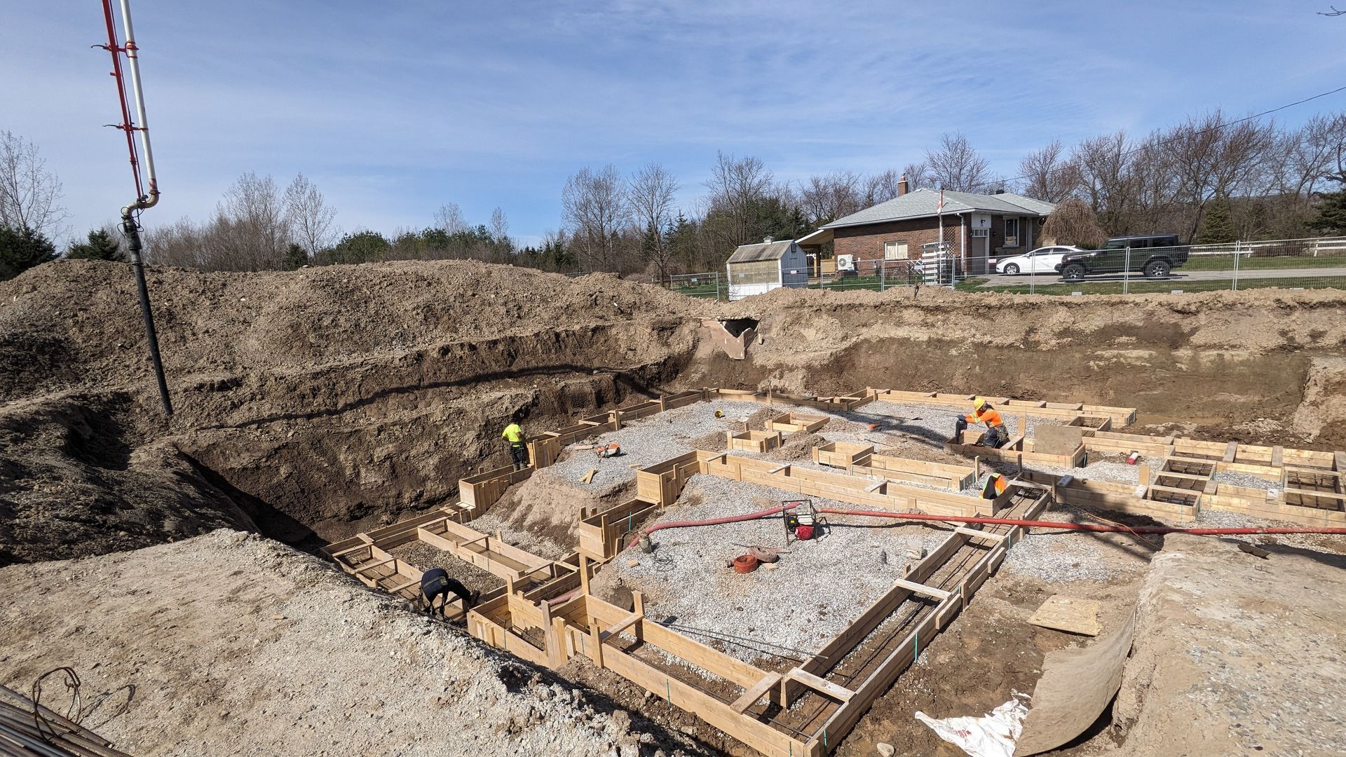 A construction site with a house in the background.