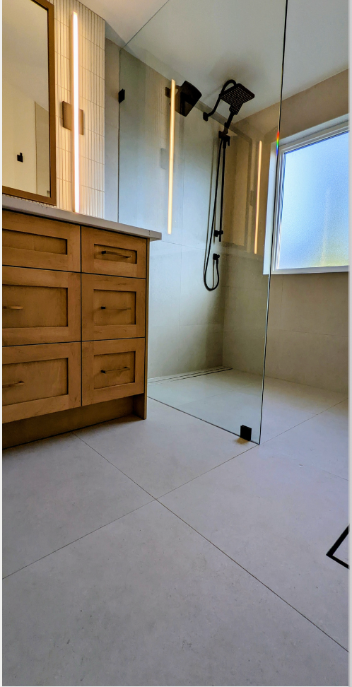 A living room with a couch , coffee table , and stairs.