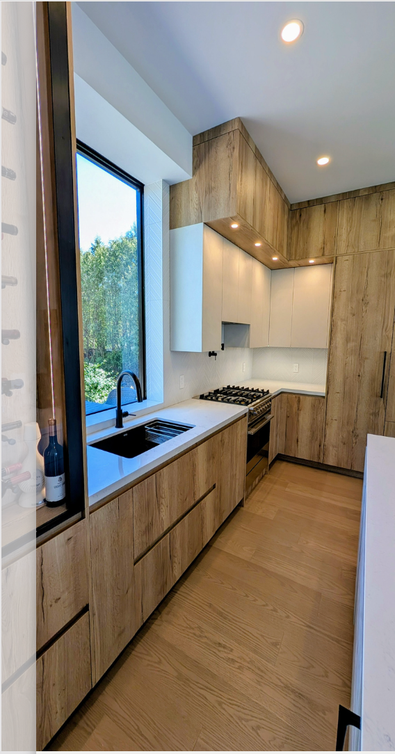 A bathroom sink with a gold faucet and a soap dispenser