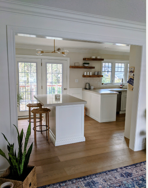 A bathroom sink with a gold faucet and a soap dispenser